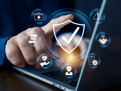 Person using a laptop with security icons and symbols on the screen