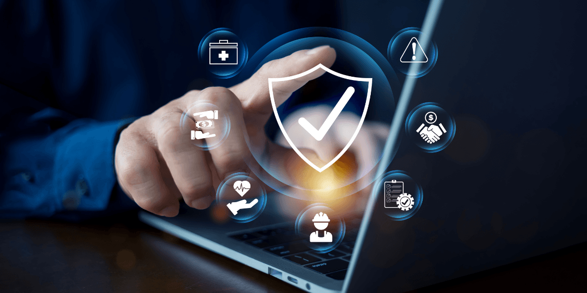 Person using a laptop with security icons and symbols on the screen