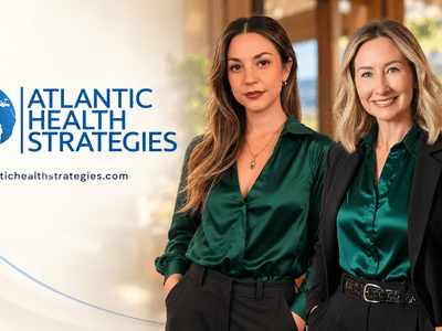 Two women in stylish green blouses pose confidently next to a logo for Atlantic Health Strategies